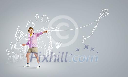 Little boy playing with kite against gray background. Childhood concept Little boy playing with kite against gray background. Childhood concept