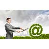 Businessman cutting green bush. Network and e-commerce
