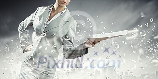 Businesswoman in suit holding documents in hands. Paperwork Businesswoman in suit holding documents in hands. Paperwork