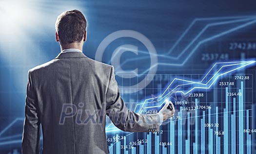 Businessman standing with back against media screen Businessman standing with back against media screen