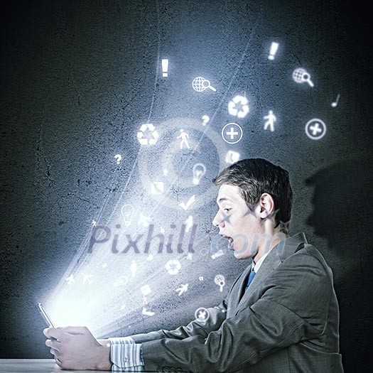 Young businessman looking surprised into tablet pc. Net and communication Young businessman looking surprised into tablet pc. Net and communication