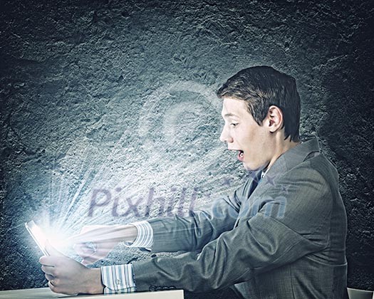 Young businessman looking surprised into tablet pc. Net and communication Young businessman looking surprised into tablet pc. Net and communication