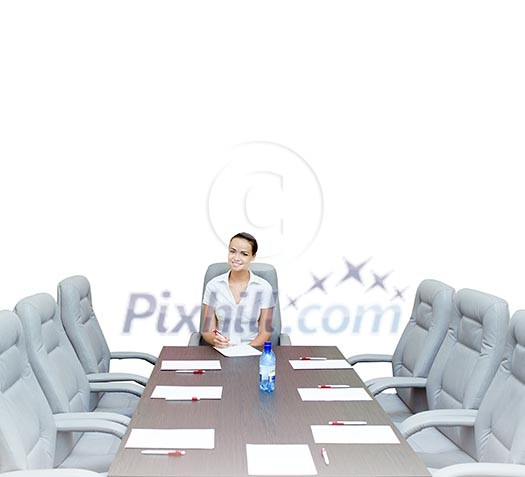 Young attractive businesswoman sitting at head of negotiating table Young attractive businesswoman sitting at head of negotiating table