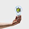 Image of human hand holding bulb with earth planet inside