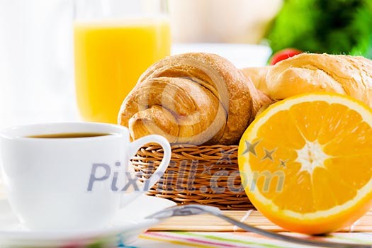 Croissants and cup of coffee on breakfast table