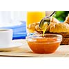 Croissants jelly and cup of coffee on breakfast table