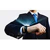 Businessman looking at wristwatch. Media technologies and innovations
