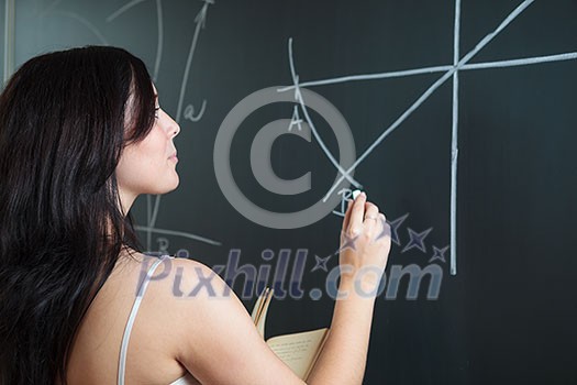Pretty, young college student drawing on the chalkboard/blackboard during a math class (shallow DOF; color toned image) Pretty, young college student drawing on the chalkboard/blackboard during a math class (shallow DOF; color toned image)