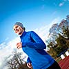 Young woman running at a track and field stadium