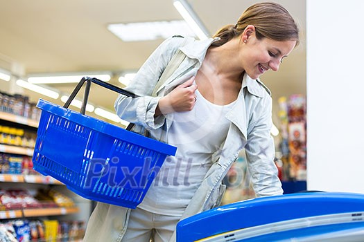 Beautiful young woman shopping in a grocery store/supermarket (color toned image) Beautiful young woman shopping in a grocery store/supermarket (color toned image)