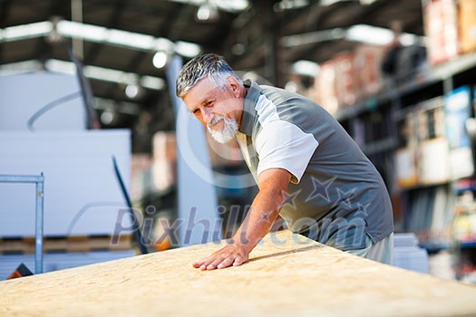 Senior man buying construction wood in a DIY store Senior man buying construction wood in a DIY store