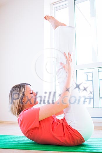 Pretty young woman doing YOGA exercise at home Pretty young woman doing YOGA exercise at home