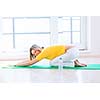 Pretty young woman doing YOGA exercise at home