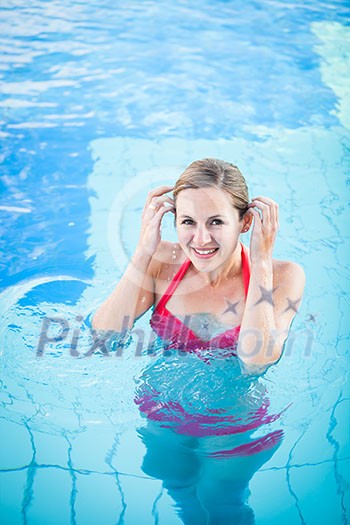 Portrait of a young woman relaxing in a swimming pool (shallow DOF; color toned image) Portrait of a young woman relaxing in a swimming pool (shallow DOF; color toned image)