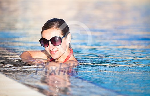 Portrait of a young woman relaxing in a swimming pool (shallow DOF; color toned image) Portrait of a young woman relaxing in a swimming pool (shallow DOF; color toned image)
