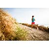 Young woman on her evening jog along the seacoast (motion blurred image)