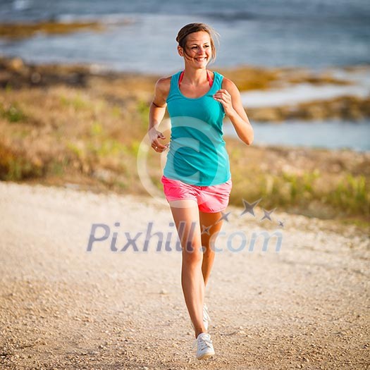Young woman on her evening jog along the seacoast Young woman on her evening jog along the seacoast