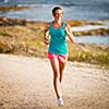 Young woman on her evening jog along the seacoast