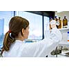 Portrait of a female researcher carrying out research in a chemistry lab (color toned image; shallow DOF)