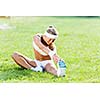Young sport woman in white stretching in park