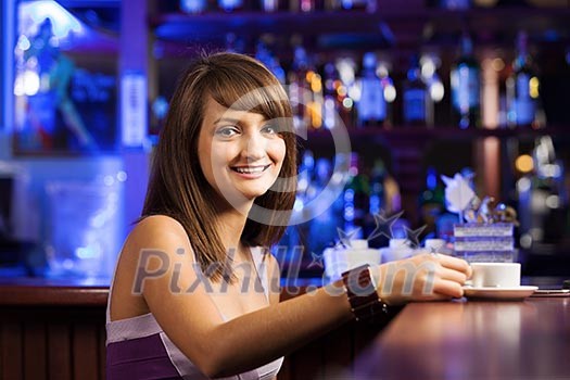 Young pretty lady sitting at bar with cup of coffee Young pretty lady sitting at bar with cup of coffee