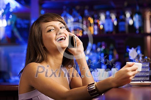 Young attractive lady at bar talking on phone Young attractive lady at bar talking on phone