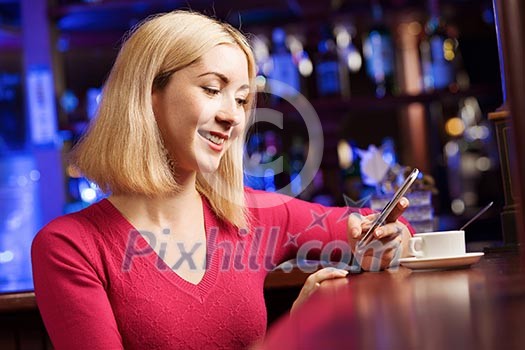 Young attractive lady at bar talking on phone Young attractive lady at bar talking on phone