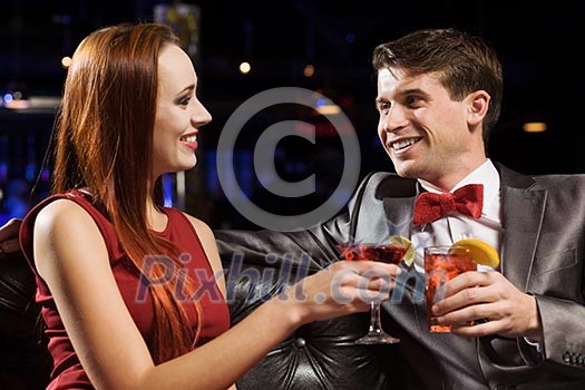 Young handsome man in restaurant accompanied by elegant lady Young handsome man in restaurant accompanied by elegant lady