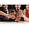 Young attractive people of four having cocktail party