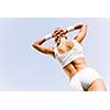 Young attractive sport girl in white sport wear in park