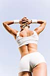 Young attractive sport girl in white sport wear in park