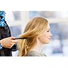 Young woman in chair at barbers and hairdresser