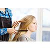 Young woman in chair at barbers and hairdresser