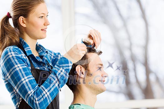 Young man in chair at barbers and woman hairdresser Young man in chair at barbers and woman hairdresser