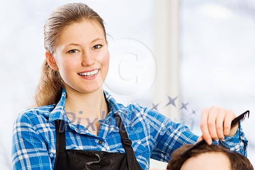 Young man in chair at barbers and woman hairdresser Young man in chair at barbers and woman hairdresser