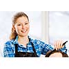 Young man in chair at barbers and woman hairdresser