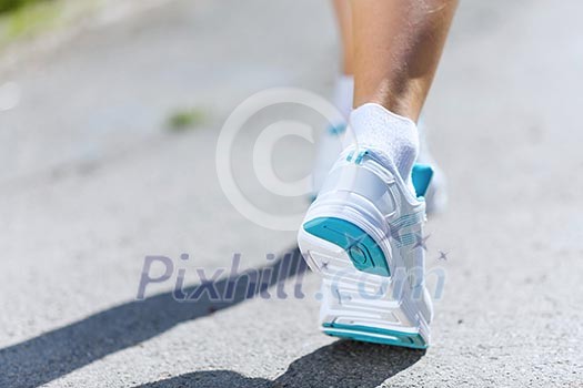 Close up of female feet running on road Close up of female feet running on road