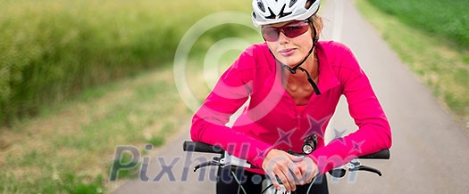 Pretty, young female biker outdoors on her mountain bike (shallow DOF; selective focus) Pretty, young female biker outdoors on her mountain bike (shallow DOF; selective focus)