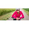 Pretty, young female biker outdoors on her mountain bike (shallow DOF; selective focus)