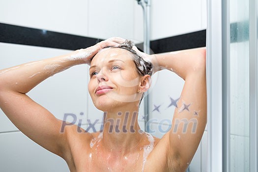 Young woman washing her hair with shampoo, taking a hot long shower Young woman washing her hair with shampoo, taking a hot long shower