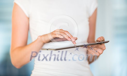 Pretty, young businesswoman/colle ge student using her tablet computer (shallow DOF; color toned image) Pretty, young businesswoman/colle ge student using her tablet computer (shallow DOF; color toned image)