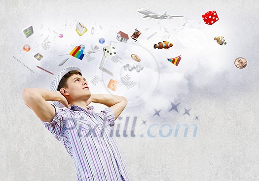 Young man in casual dreaming about future Young man in casual dreaming about future