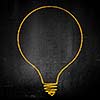 Conceptual image of light bulb on black wall