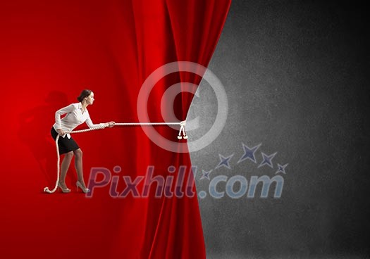 Young businesswoman pulling curtain with rope. Place for text Young businesswoman pulling curtain with rope. Place for text
