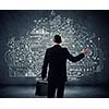 Rear view of businessman looking at chalk sketches on wall