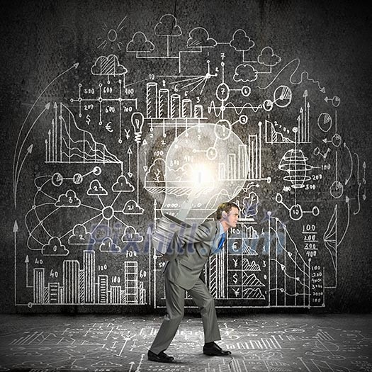Young businessman carrying light bulb on his back Young businessman carrying light bulb on his back