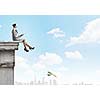 Businesswoman fishing with rod on top of building