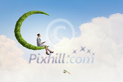 Businesswoman fishing with rod on green moon