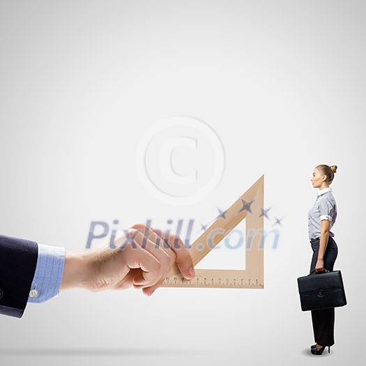 Businessman measuring miniature of business lady with ruler Businessman measuring miniature of business lady with ruler