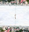 Businesswoman standing on ladder between two realities